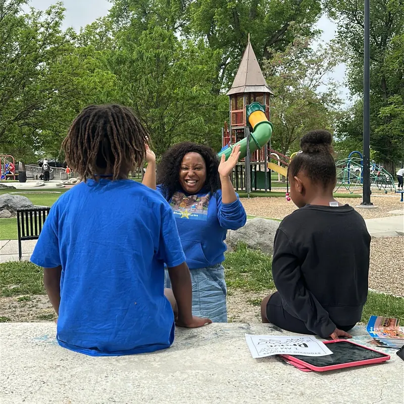 Kids listening together outside at a playground